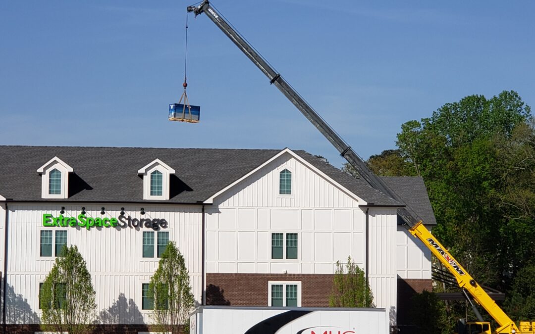 crane lifting pallets over building