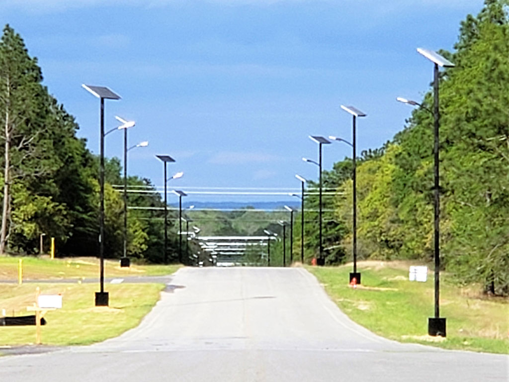 Solar powered street lights lining both sides of a street. 